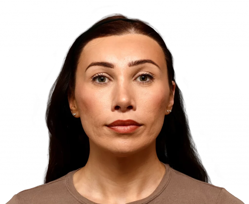 Front-facing portrait of a woman with dark hair and a neutral expression against a black background.