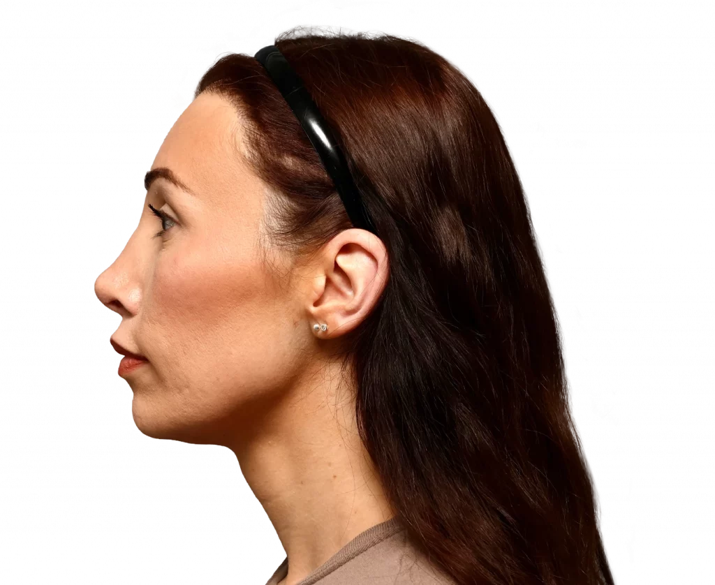 Side profile of a woman wearing a black headband headset, looking to the left, with long brown hair and small earrings.